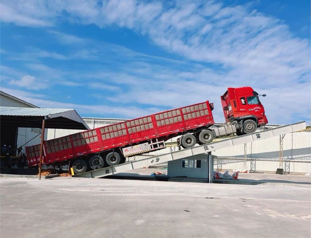 液壓卸車機、后翻式液壓翻板卸車平臺、河南愛信液壓翻板機